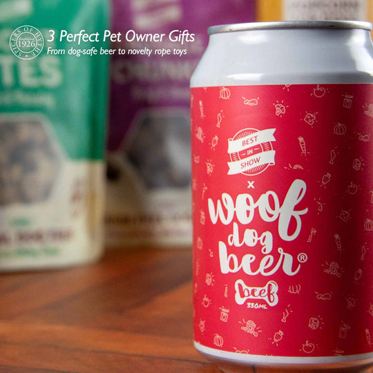 A can of Woof Dog Beer by Best In Show, laid out in front of biscuit bites & sausage snack dog treats.
