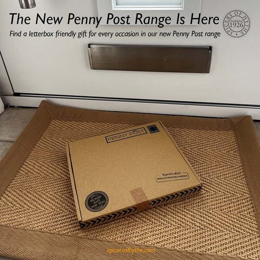 A Penny Post gift box laid through the letterbox of a house.